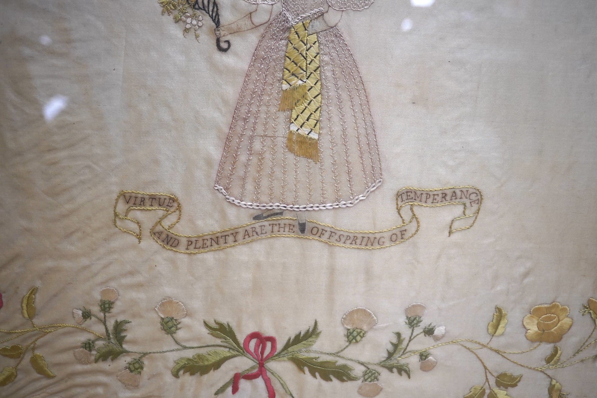 A mid 20th century, appliqué on silk 19th century lady walking in a classical garden by lake (possibly Italy), together with a silk embroidery “virtue and plenty are the off spring of temperance”, appliqué 38.5cm x 57cm.